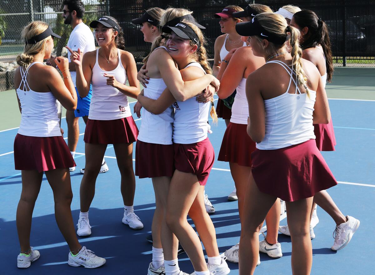 The Laguna Beach High girls' tennis team congratulates each other after winning the CIF Southern Section Division 2 title.