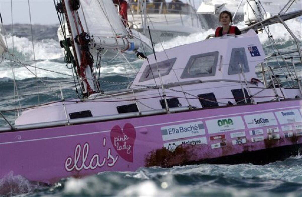 Sixteen-year-old Jessica Watson sails past the finish line at the entrance to Sydney Harbour in Sydney, Australia, Saturday, May 15, 2010, capping off a nearly 23,000 nautical miles voyage. Watson crossed the finish line of her round-the-world journey Saturday, becoming the youngest person to sail solo, nonstop and unassisted around the world. (AP Photo/Rob Griffith)