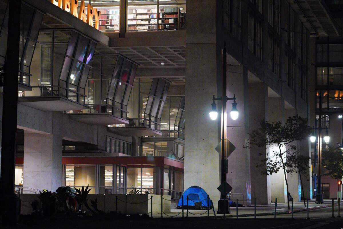 Tents housing the homeless set up for the night in front of San Diego Central Library. 