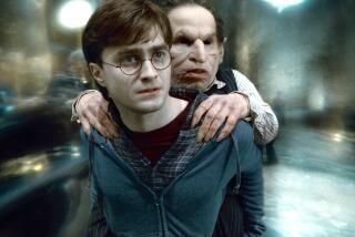 DANIEL RADCLIFFE as Harry Potter and WARWICK DAVIS as Griphook