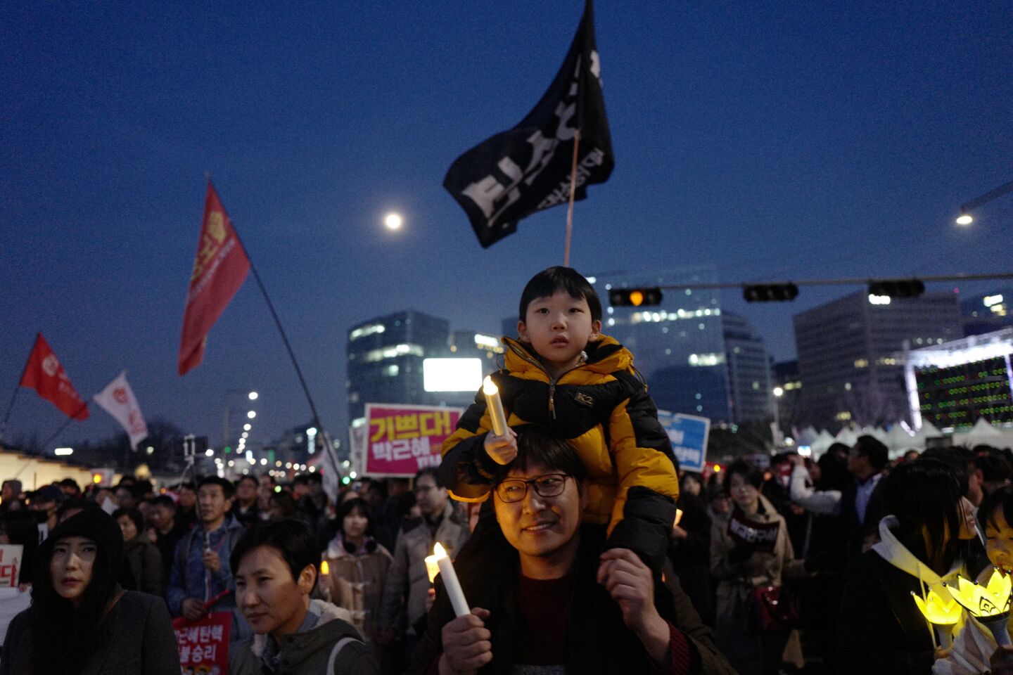 South Koreans celebrate the impeachment of President Park Geun-hye on Saturday in downtown Seoul.