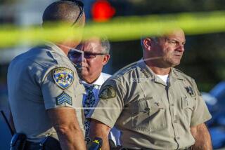 Riverside County Sheriff Chad Bianco, right, with Riverside City Police Chief Sergio G. Diaz, center, and a California Highway Patrol officer gather information after a shootout near a freeway killed a CHP officer and wounded two others before the gunman was fatally shot, Monday, Aug. 12, 2019, in Riverside, Calif. (Terry Pierson/The Orange County Register via AP)