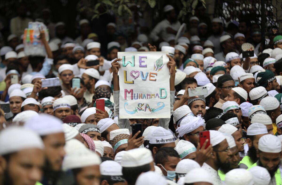 Muslims for a protest against Nupur Sharma, a spokesperson of India's governing Hindu nationalist Bharatiya Janata Party, as they react to the derogatory references to Islam and the Prophet Muhammad made by her, during a protest outside a mosque in Dhaka, Bangladesh, Thursday, June 16, 2022. Thousands of people marched in Bangladesh’s capital on Thursday to demand the governments of Bangladesh and India officially condemn the comments by two Indian governing party officials deemed derogatory to Islam’s Prophet Muhammad. (AP Photo/Mahmud Hossain Opu)