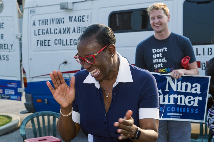 In this July 7, 2021, photo Nina Turner, a candidate running in a special Democratic primary election for Ohio's 11th Congressional District reacts as she speaks with supporters near the Cuyahoga County Board of Elections before casting her vote in Cleveland. (AP Photo/Phil Long)