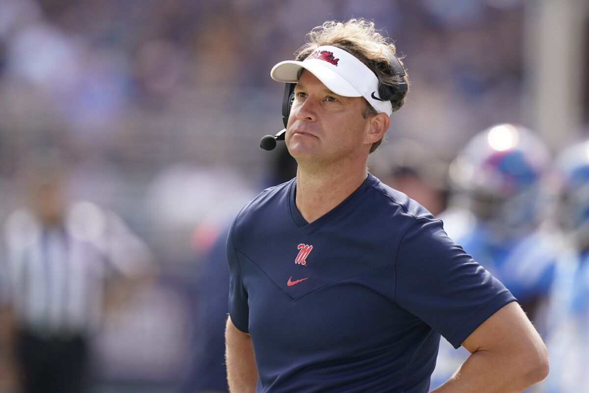 Mississippi head coach Lane Kiffin looks at the stadium monitor during the second half of an NCAA college football game against Arkansas, Saturday, Oct. 9, 2021, in Oxford, Miss. Mississippi won 52-51.(AP Photo/Rogelio V. Solis)