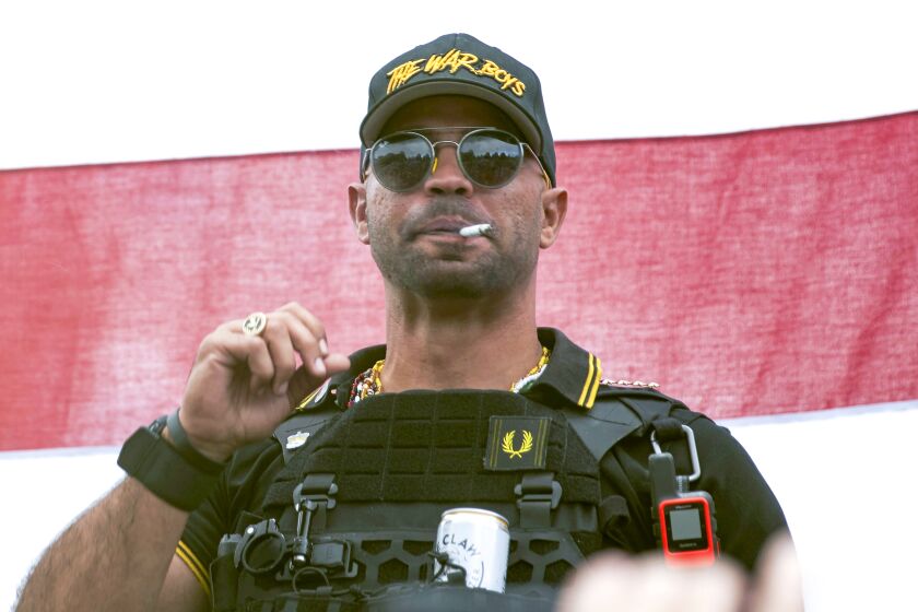 FILE - Proud Boys leader Henry "Enrique" Tarrio wears a hat that says The War Boys during a rally in Portland, Ore., Sept. 26, 2020. Tarrio, the former top leader of the Proud Boys, will remain jailed while awaiting trial on charges that he conspired with other members of the far-right extremist group to attack the U.S. Capitol and stop Congress from certifying President Joe Biden's 2020 electoral victory, a federal judge has ruled. (AP Photo/Allison Dinner, File)