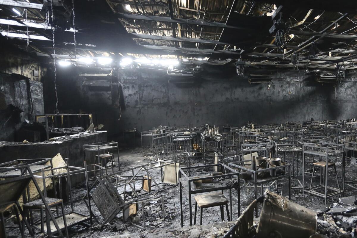 Major fire damage fills the interior at the Mountain B pub in the Sattahip district of Chonburi province, about 160 kilometers (100 miles) southeast of Bangkok, Thailand. Over a dozen people were killed and dozens injured when a fire broke out early Friday morning at the crowded music pub, police and rescue workers said. (AP Photo/Anuthep Cheysakron)