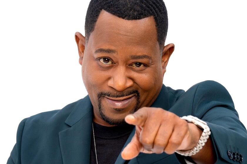 Martin Lawrence, close-up, pointing at the camera with a watch on his wrist