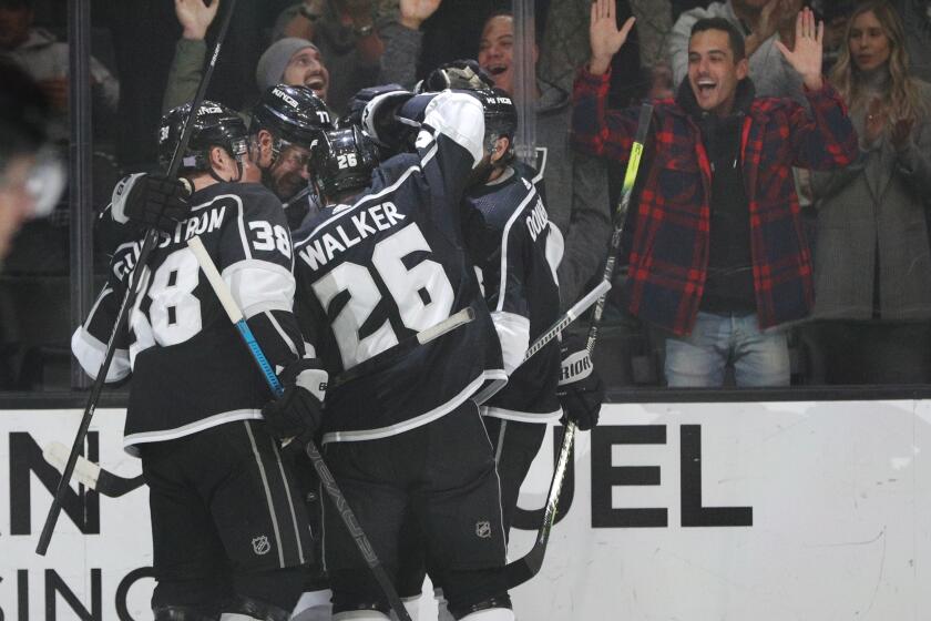 Kings center Tyler Toffoli (73) is surrouned by his teammates after scoring a goal against the Oilers during the first period of a game Nov. 21 at Staples Center.