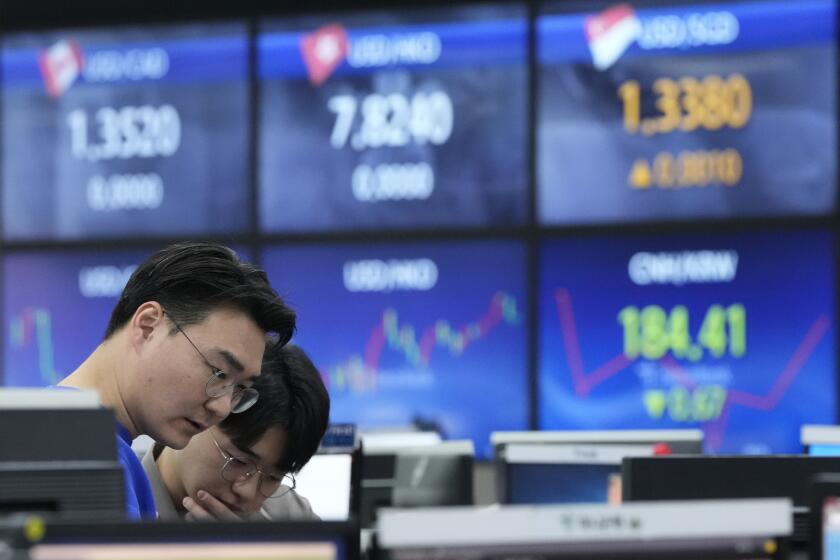 Currency traders work at the foreign exchange dealing room of the KEB Hana Bank headquarters in Seoul, South Korea, Thursday, March 7, 2024. Asian shares were mostly higher in early Thursday trading, after Wall Street recovered some losses from the day before. (AP Photo/Ahn Young-joon)
