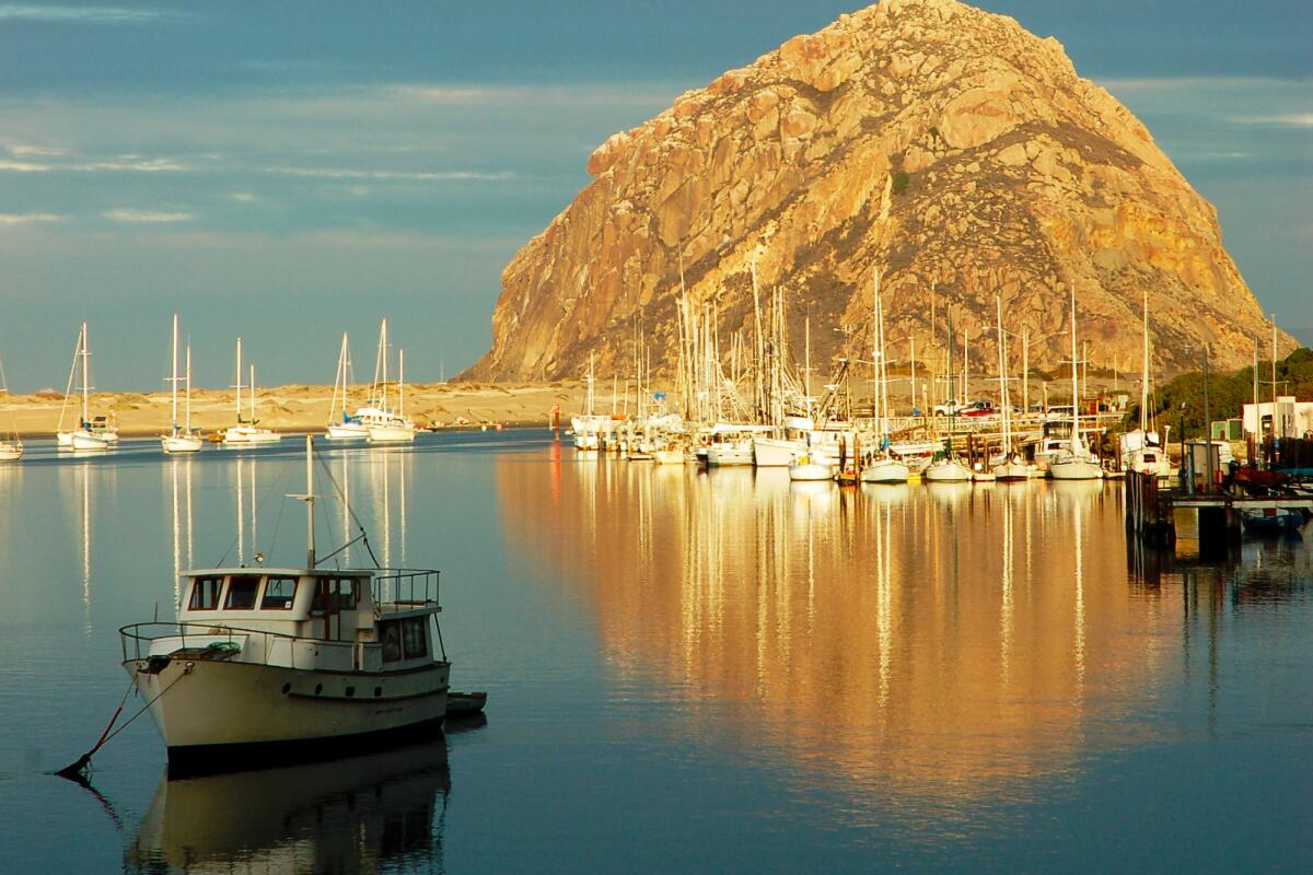 Morro Rock is reflected in the water at Morro Bay State Park.