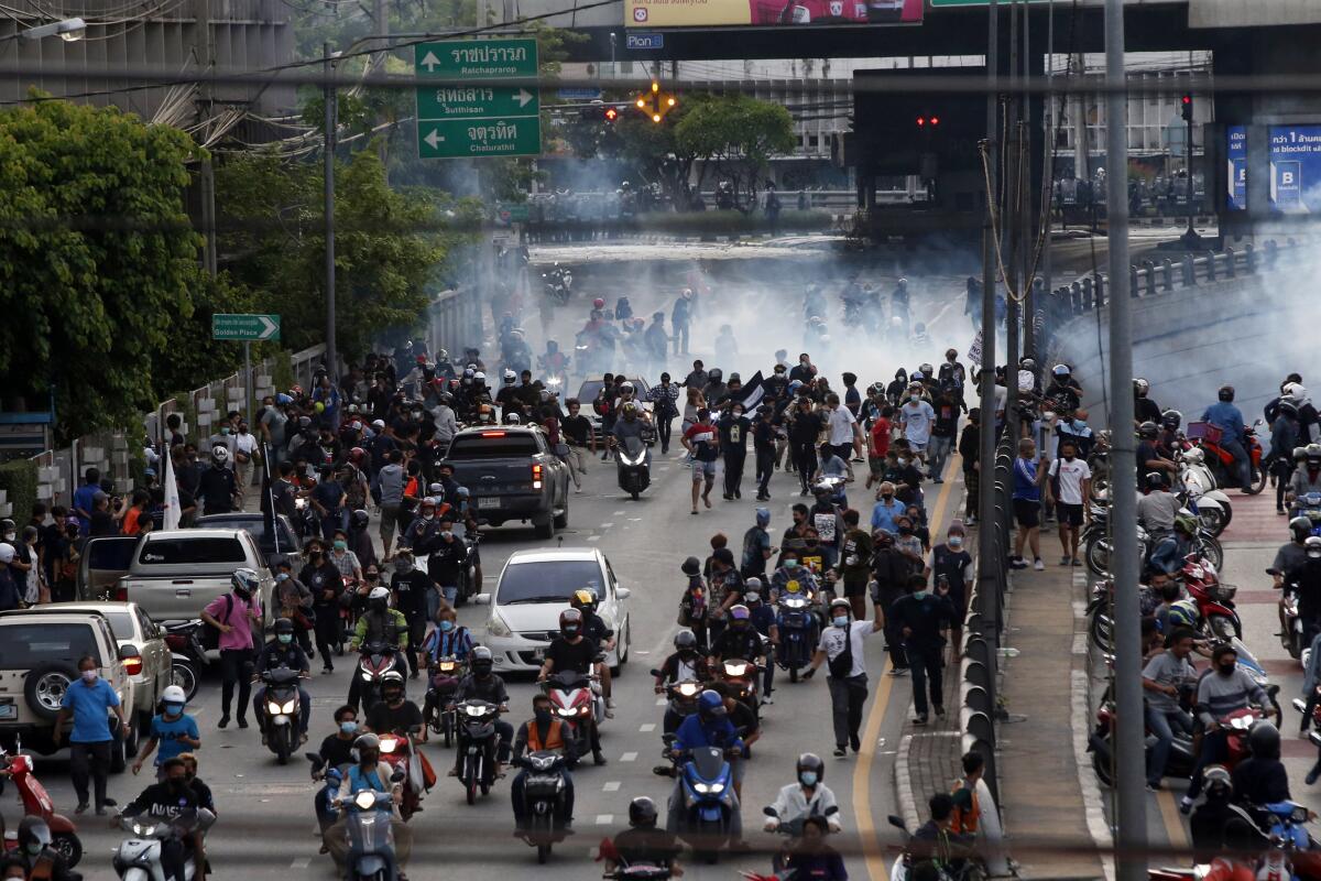 Riot police launch tear gas at anti-government protesters during a protest in Bangkok, Thailand, Tuesday, Aug. 10, 2021. Protesters demanded the resignation of Prime Minister Prayuth Chan-ocha for his failure in handling the COVID-19 pandemic. (AP Photo)