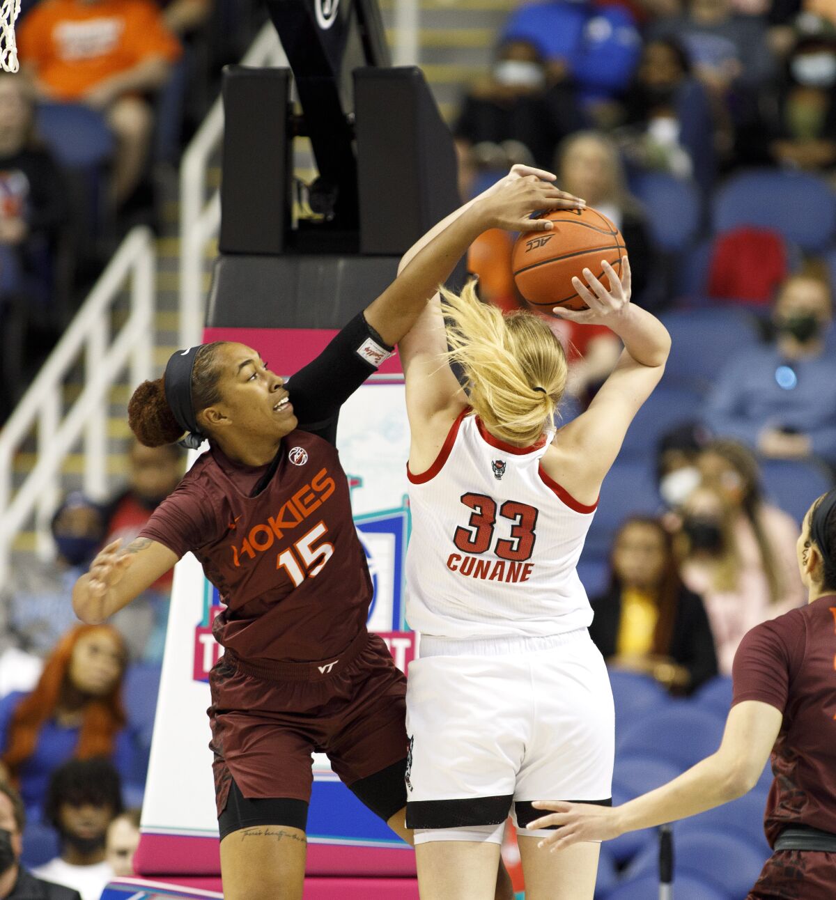 Virginia Tech guard Azana Baines (15) blocks the shot of North Carolina State center Elissa Cunane (33) during the first half of an NCAA college basketball game in the semifinals of the Atlantic Coast Conference women's tournament in Greensboro, N.C., Saturday, March 5, 2022. (AP Photo/Lynn Hey)