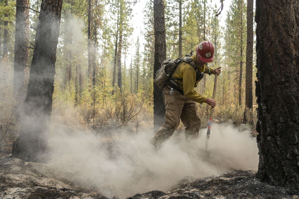 A firefighter works on the Bootleg fire in Oregon.