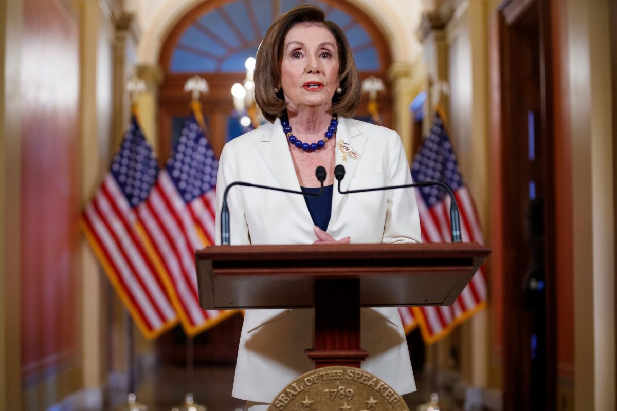 Speaker Nancy Pelosi talking at a lectern