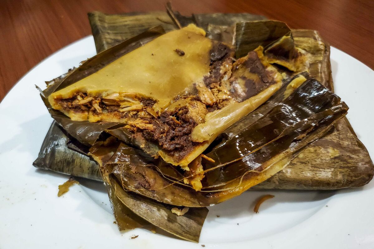 Poncho's tamale comes wrapped in aromatic avocado leaf.
