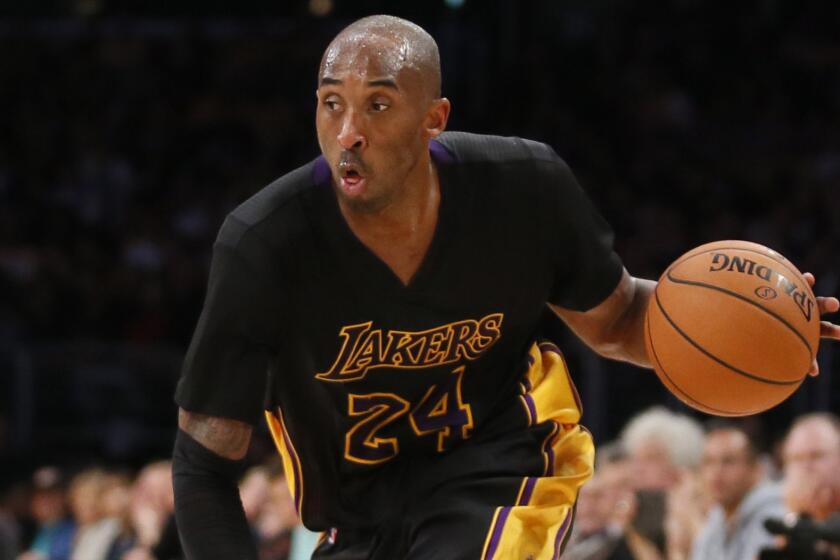 Lakers star Kobe Bryant dribbles the ball during a loss to the Minnesota Timberwolves on Friday.