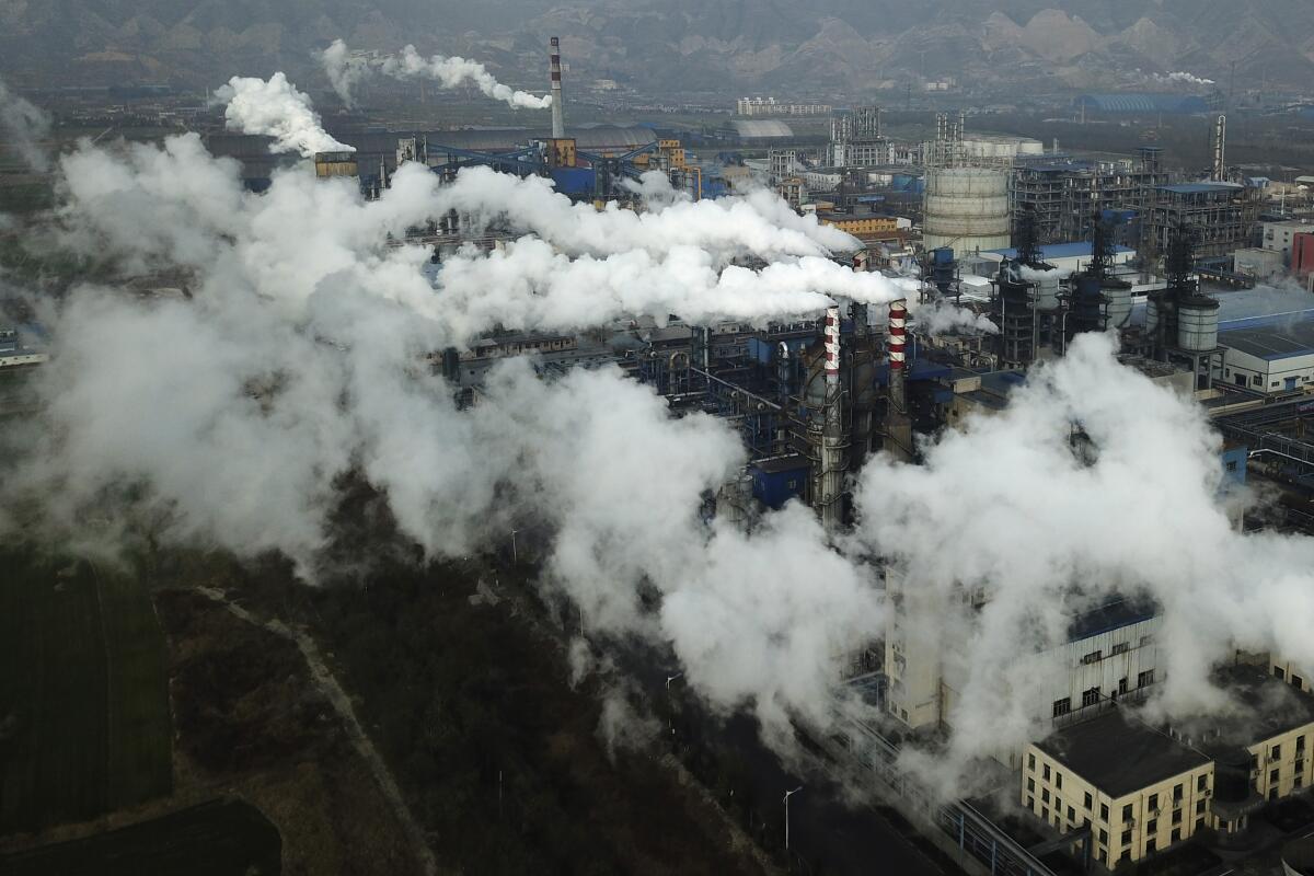 Smoke rises from factories.