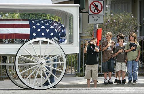 Children show their respect for a soldier who lost his life in Iraq. A horse-drawn carriage conveys the coffin of Army Pfc. Joseph J. Anzack Jr., 20, to a service Friday at South High in Torrance, where he played football. Anzack was captured in an ambush near Baghdad on May 12, but his body wasn't found for nearly two weeks.