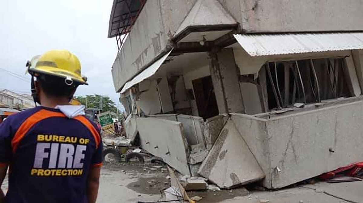 A rescuer is pictured near a collapsed building in the southern Philippines following an earthquake on Sunday. At least five people died in the magnitude 6.9 quake that struck Davao del Sur province’s Padada town and outlying rural towns, cities and provinces.