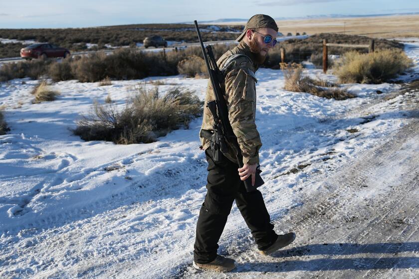 A protester keeps watch this month during the armed occupation of the Malheur National Wildlife Refuge in Oregon. The FBI kept a low profile but monitored statements the protesters were making on social media and elsewhere.
