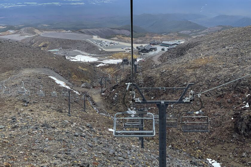 The ski slopes are almost devoid of snow at the Tūroa ski field, on Mt. Ruapehu, New Zealand on Sept. 22, 2022. A disastrous snow season has left two of New Zealand's largest ski fields on the brink of bankruptcy, with climate change appearing to play a significant role. (AP Photo/Nick Perry)