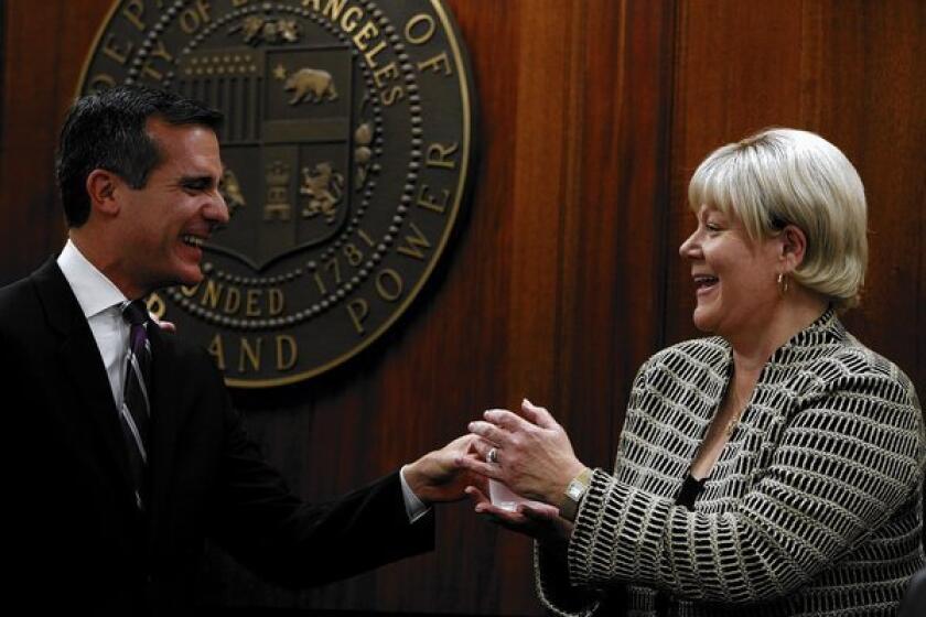 Los Angeles Mayor Eric Garcetti, left, introduces Marcie Edwards, his choice to lead the DWP, in January. Edwards worked for the DWP for more than two decades and is now Anaheim's city manager.