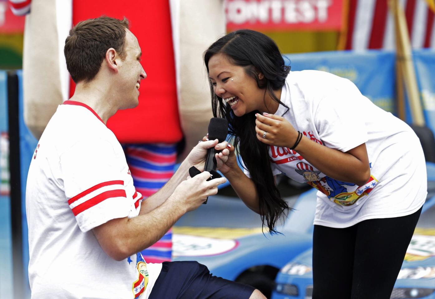 Champion eater Joey Chestnut proposes at Nathan's hot dog eating contest on Coney Island, N.Y., on Friday.