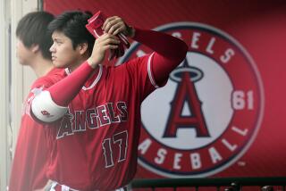 Los Angeles Angels' Shohei Ohtani prepares to bat while in the dugout during the fourth inning.