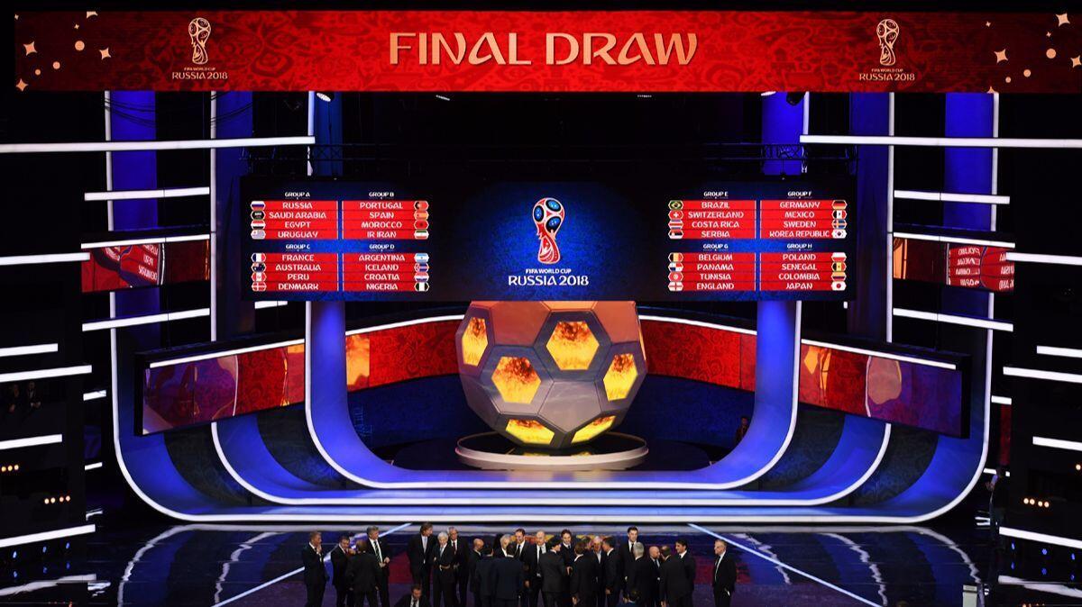A general view as the national team managers pose for a photo onstage during the Final Draw for the 2018 FIFA World Cup Russia in Moscow.