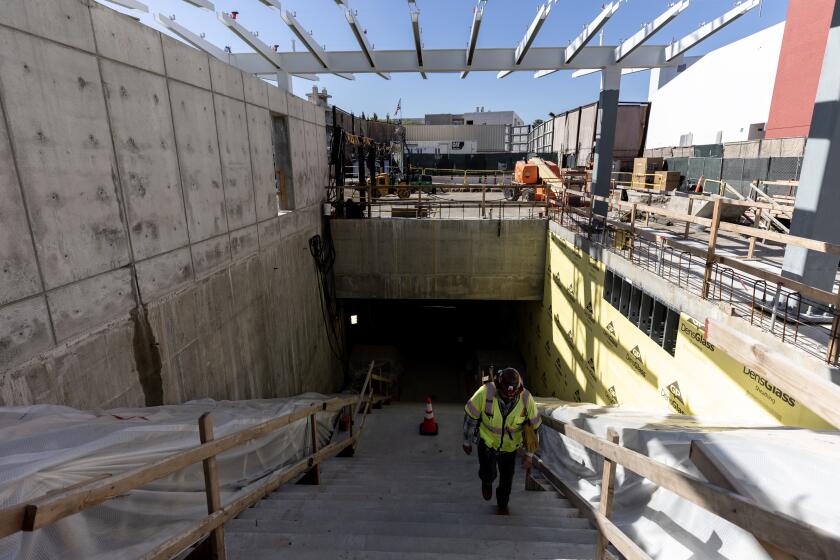 A construction worker exits the future Wilshire/Fairfax metro station during an event celebrating the completion of tunneling operations for the Metro D Line Subway Extension Project in Los Angeles, California, USA, 01 April 2024. The event marks the successful completed tunneling for the entire 9-mile underground alignment between the current Wilshire/Western D (Purple) Line station terminus in Koreatown and Westwood/VA Hospital. (Etienne Laurent / For the Times)