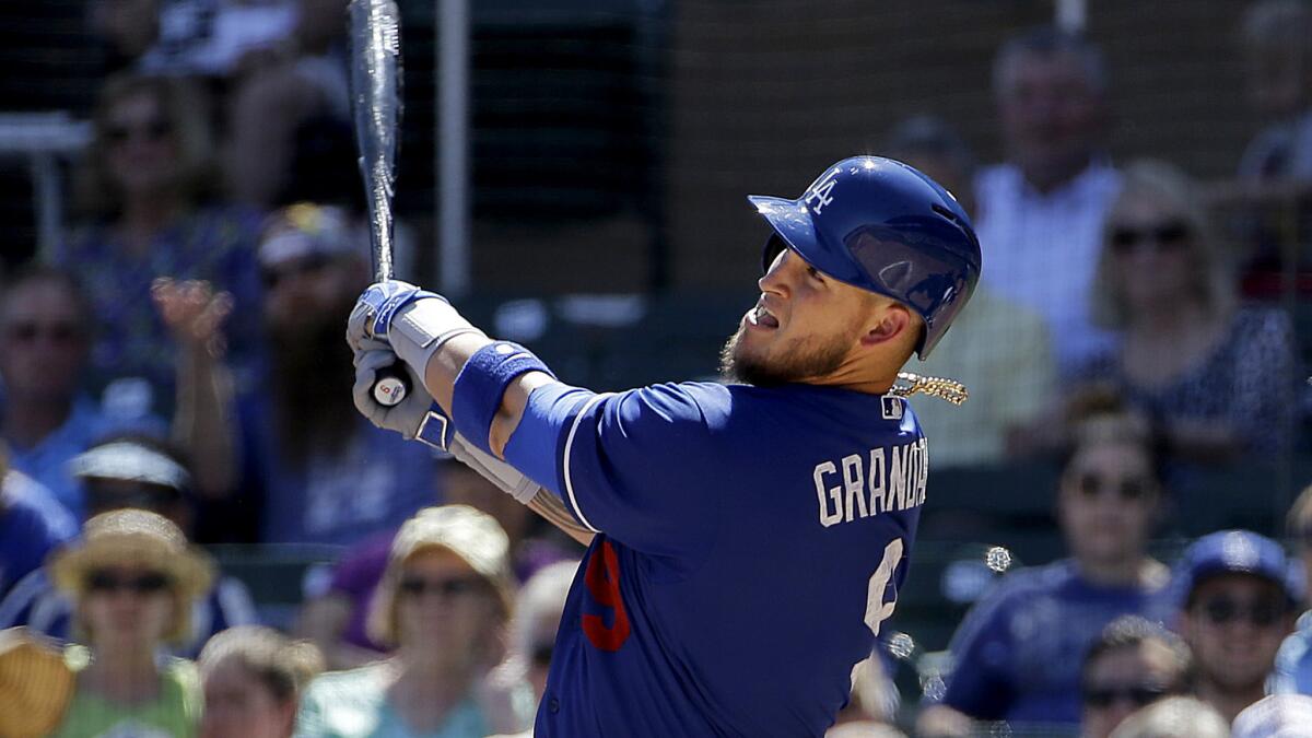 Dodgers catcher Yasmani Grandal hits a two-run home run against the Diamondbacks during spring training game on March 18.