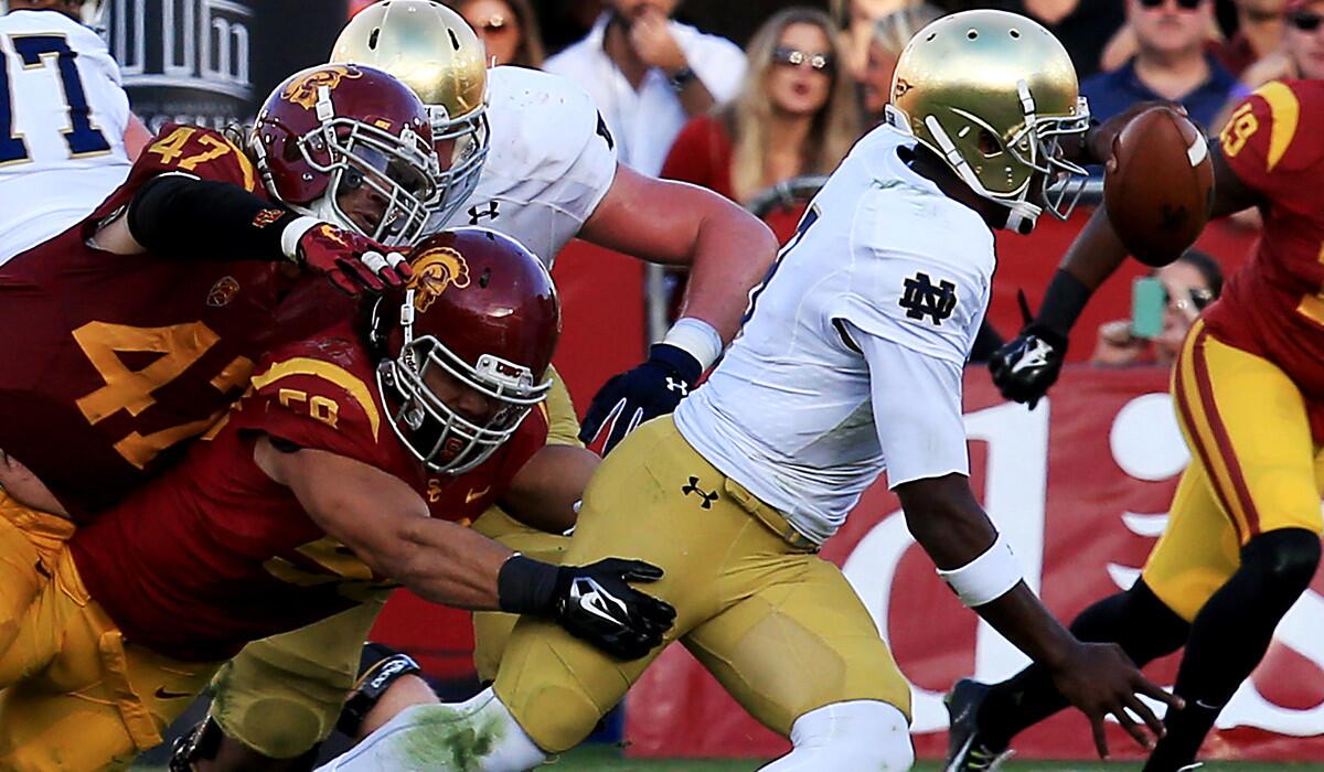 Notre Dame quarterback Malik Zaire, getting brought down by USC linebackers J.R. Tavai and Scott Felix (47) will make his first career start in the Music City Bowl on Tuesday when the Irish try to snap a five-game losing streak.