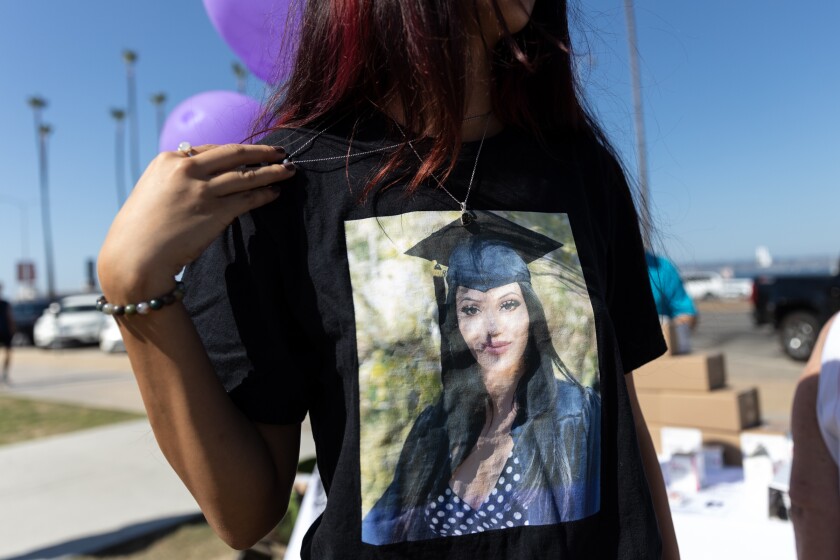 Aysia Jones shows a picture of her late cousin, Pariss Rodriguez, during a International Overdose Awareness Day event.