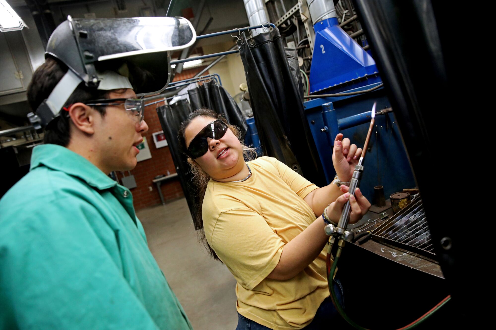 Two people in a workshop.