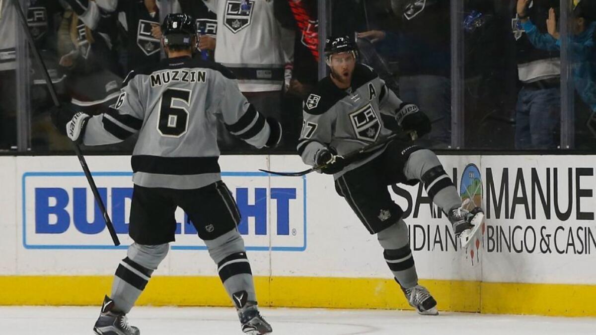 Kings forward Jeff Cater celebrates with defenseman Jake Muzzin after scoring a goal on the Flames during the first period of a game at Staples Center on Nov. 5.