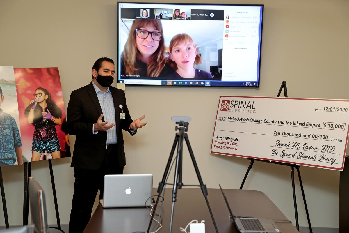 Dr. Burak Ozgur, left, speaks during a Zoom call with Olivia La Loggia, 10, of Huntington Beach, and her mother, Erika. 
