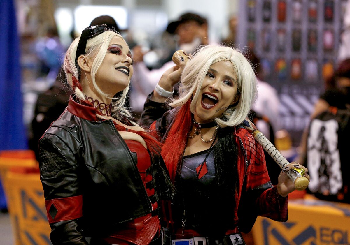 Angela Jones, left, and Meli Lopez laugh  during WonderCon Anaheim.