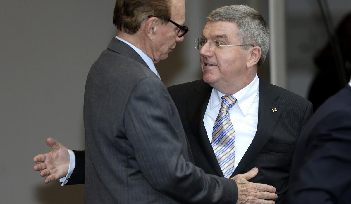 IOC President Thomas Bach, right, welcomes IOC executive board member Willy Kaltschmitt Lujan before their meeting in Monaco on Friday.