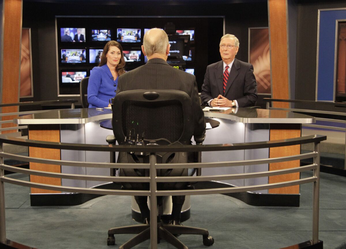 Senate Minority Leader Mitch McConnell, right, and Kentucky Secretary of State Alison Lundergan Grimes prepare to start their campaign debate on Monday.
