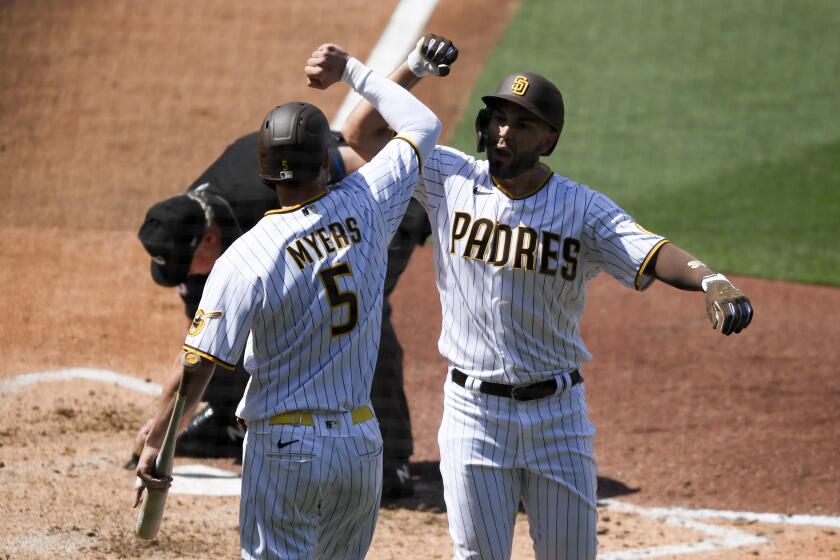 San Diego Padres' Eric Hosmer, right, is congratulated by teammate Wil Myers after hitting a solo home run during the third inning of a baseball game against the Arizona Diamondbacks, Thursday, April 1, 2021, on opening day in San Diego. (AP Photo/Denis Poroy)