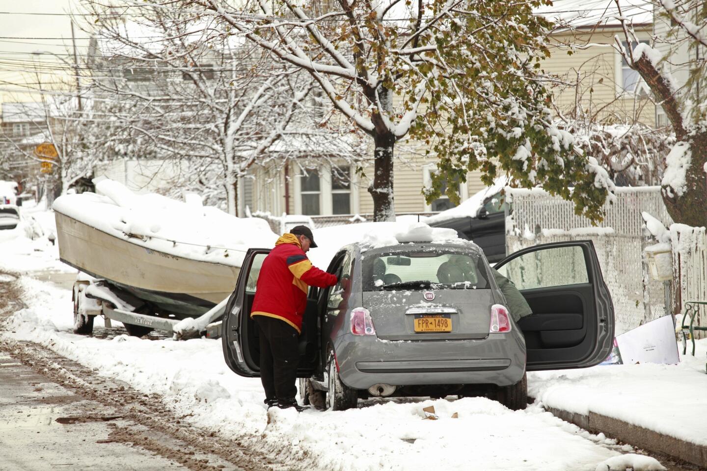 In the neighborhood of New Dorp in Staten Island, N.Y., 3 to 4 inches of snow blanketed the area, making the cleanup effort from super storm Sandy that much more difficult. Most residents have left because of lack of electricity and services.