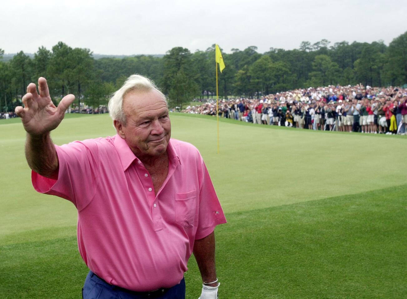 Arnold Palmer waves to the gallery as he completes his last competitive round in the Masters tournament in 2002.