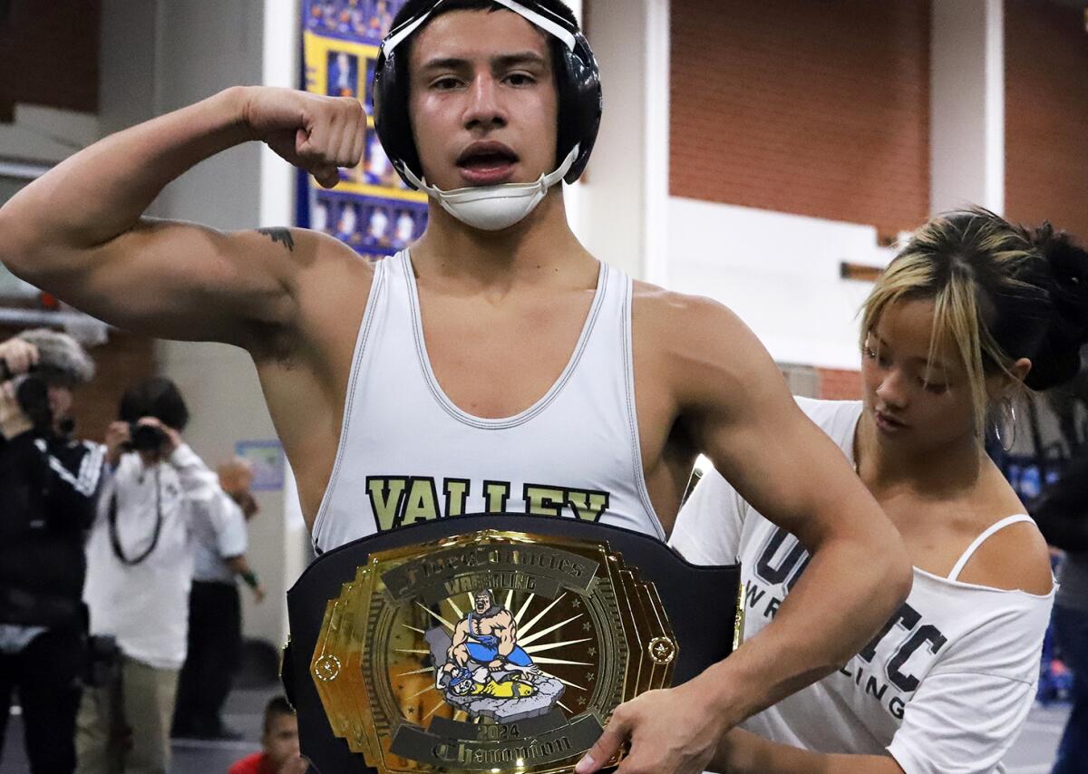 Fountain Valley's Anthony Lucio flexes after winning his his weight class during the Five Counties tournament on Jan. 13.