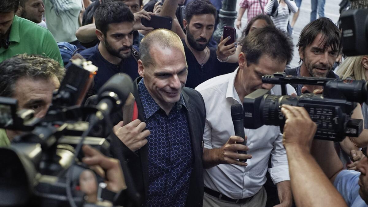 Yanis Varoufakis, center, when he was Greece's finance minister in 2015. His new book is 'Talking to My Daughter About the Economy, or How Capitalism Works -- And How It Fails'