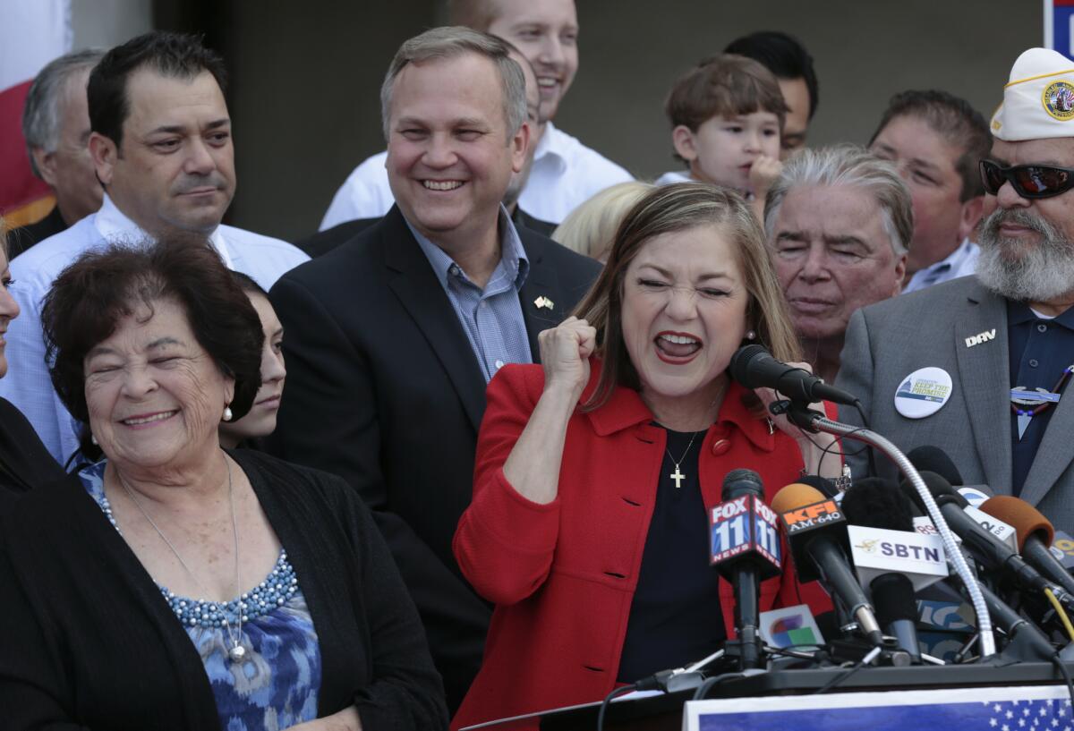 With her mother, Maria Macias, left, and her husband Jack Einwechter behind her, Rep. Loretta Sanchez announces that she will run for Barbara Boxer's seat in the U.S. Senate in May, 2015.