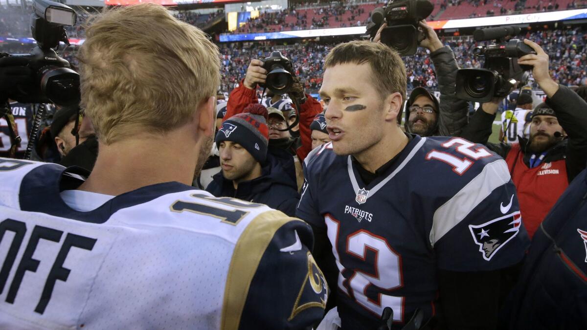 New England Patriots quarterback Tom Brady, right, speaks to Rams quarterback Jared Goff at midfield on Dec. 4, 2016