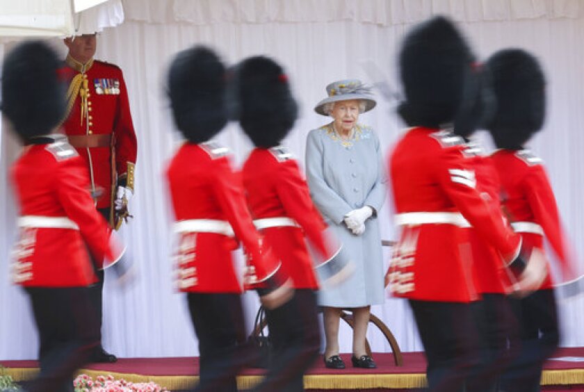 Britain's Queen Elizabeth II watches a ceremony to mark her official birthday at Windsor Castle, Windsor, England, Saturday June 12, 2021. In line with government advice The Queen's Birthday Parade, also known as Trooping the Colour, will not go ahead in its traditional form. (Chris Jackson/Pool via AP)