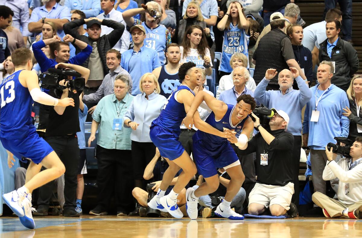 Duke's Wendell Moore, right, and teammate Jordan Goldwire react after Moore's winning basket Feb. 8, 2020.