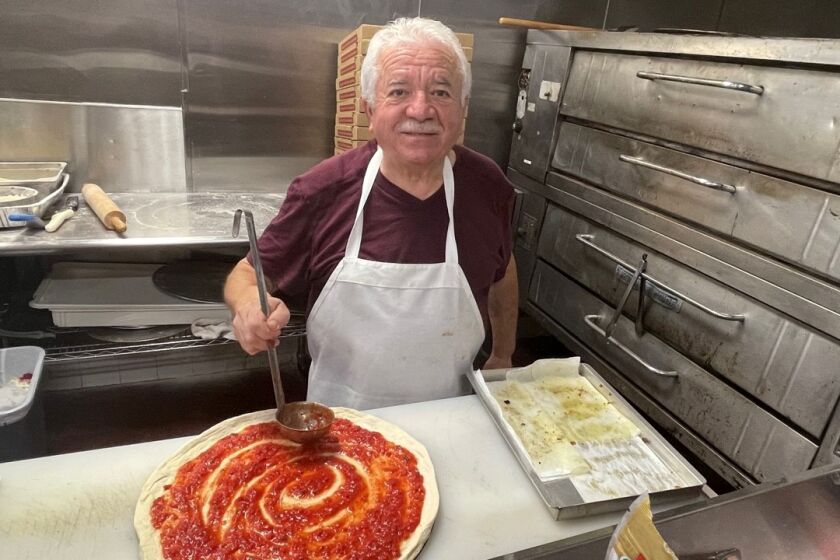 Alfredo DiNunzio says he never uses canned pizza sauce. Instead, he makes his pomodoro sauce from freshly ground tomatoes.